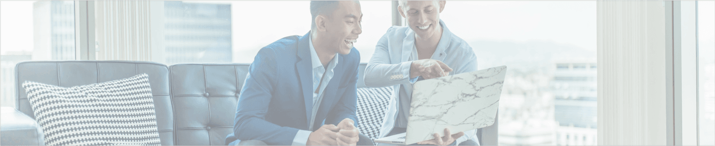 A banner image of a mortgage hero showing two people smiling while looking at a laptop.